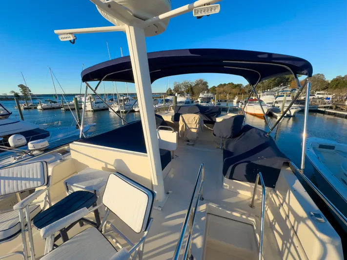 Vitamin Sea Yacht Photos Pics 2005 Mainship 34 Trawler docked at marina under clear blue sky.
