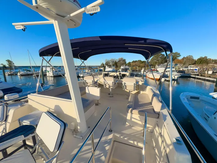 Vitamin Sea Yacht Photos Pics 2005 Mainship 34 Trawler with spacious deck and seating, docked at marina.