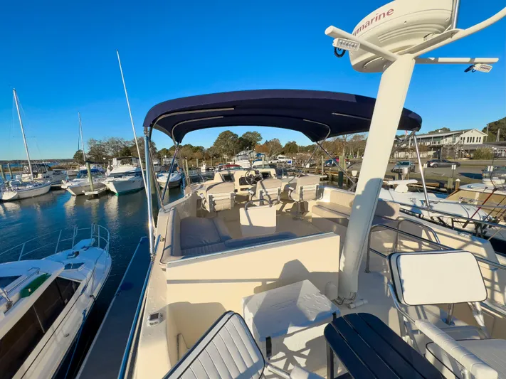 Vitamin Sea Yacht Photos Pics 2005 Mainship 34 Trawler docked at marina under clear blue sky.