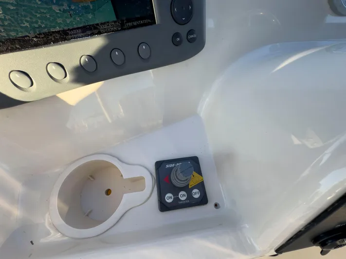 Vitamin Sea Yacht Photos Pics Control panel of a 2005 Mainship 34 Trawler with thruster switch and cup holder.