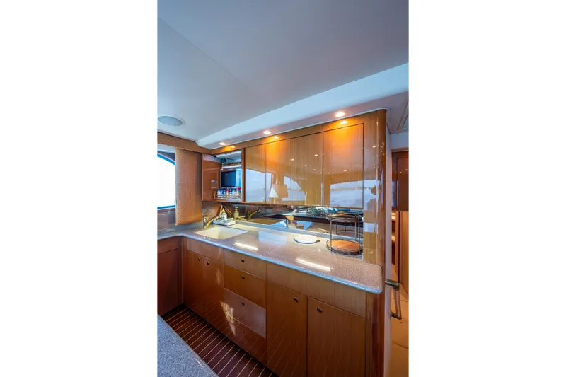Sweet Melissa Yacht Photos Pics Luxurious kitchen interior of 2004 Viking 48 Convertible yacht with wooden cabinetry.