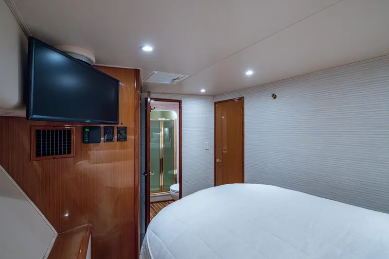 Sweet Melissa Yacht Photos Pics Interior of 2004 Viking 48 Convertible yacht bedroom with TV and ensuite bathroom.