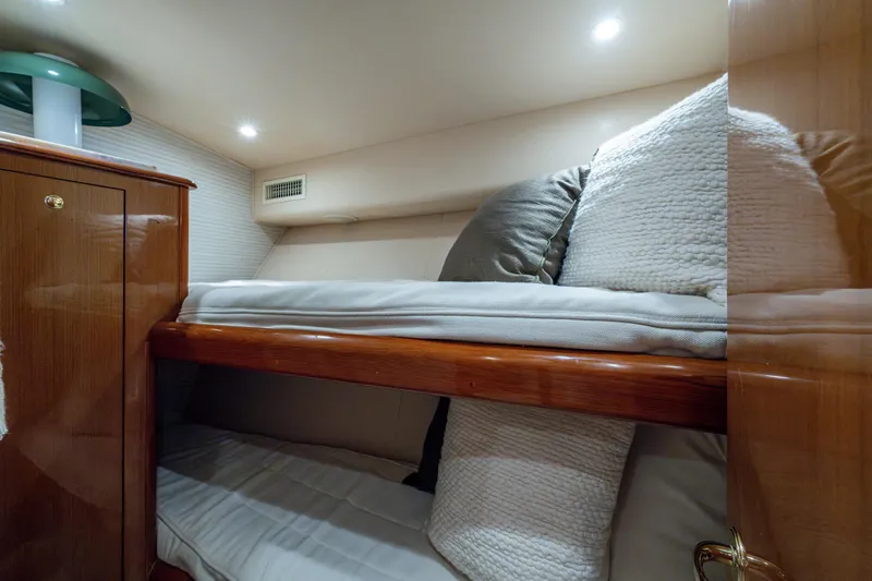 Sweet Melissa Yacht Photos Pics Bunk beds in 2004 Viking 48 Convertible yacht cabin with cozy pillows and wooden cabinetry.