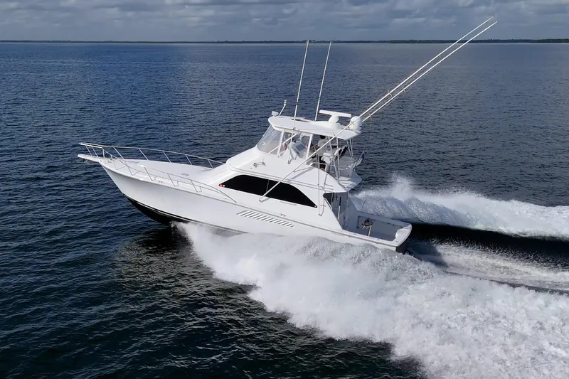 Sweet Melissa Yacht Photos Pics 2004 Viking 48 Convertible yacht cruising swiftly on open water.