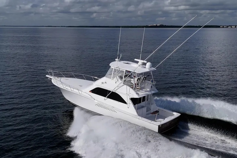 Sweet Melissa Yacht Photos Pics 2004 Viking 48 Convertible yacht cruising on open water under cloudy skies.