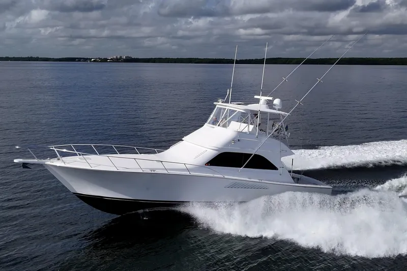 Sweet Melissa Yacht Photos Pics 2004 Viking 48 Convertible yacht cruising on open water under cloudy skies.