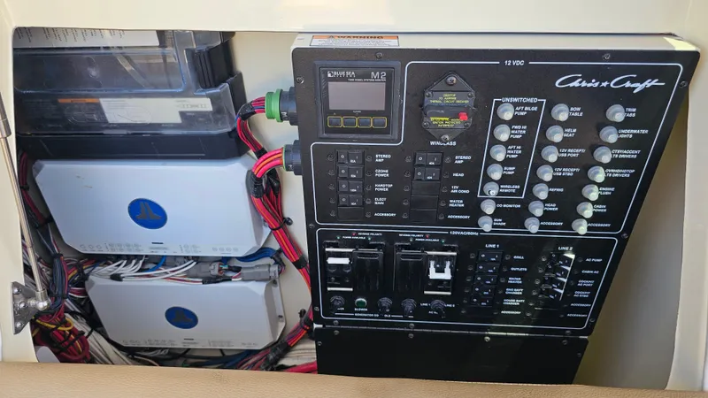  Yacht Photos Pics Electrical control panel of 2022 Chris-Craft Calypso 35 boat with wiring and switches.