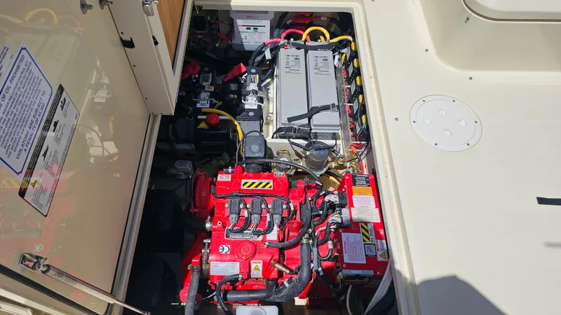 Yacht Photos Pics Engine compartment of 2022 Chris-Craft Calypso 35, showcasing batteries and wiring.