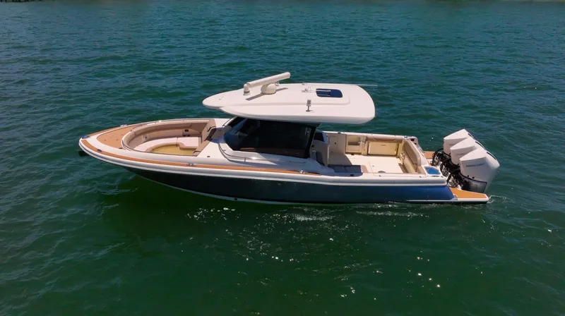  Yacht Photos Pics 2022 Chris-Craft Calypso 35 boat on open water, featuring sleek design and dual outboard engines.