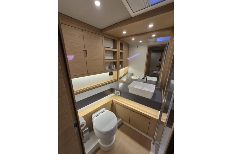  Yacht Photos Pics Luxurious bathroom in 2023 Pardo Yachts GT52, featuring modern fixtures and elegant wood cabinetry.