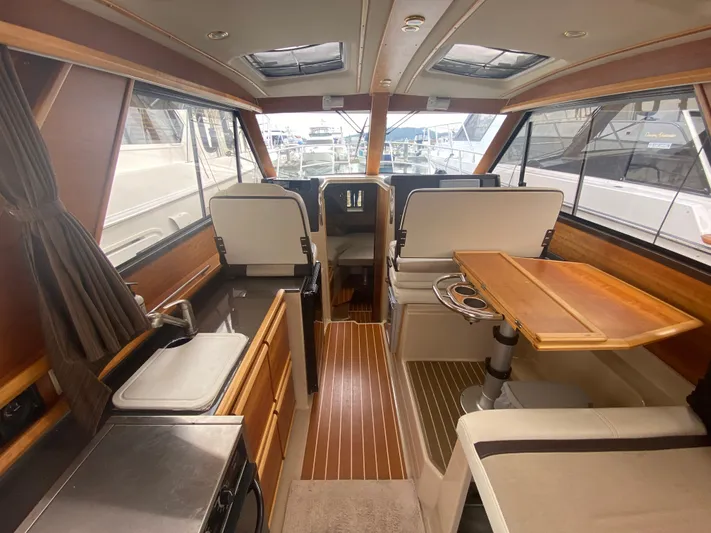  Yacht Photos Pics Interior of a 2015 Cutwater C-28 boat, featuring a modern cabin with wood accents.