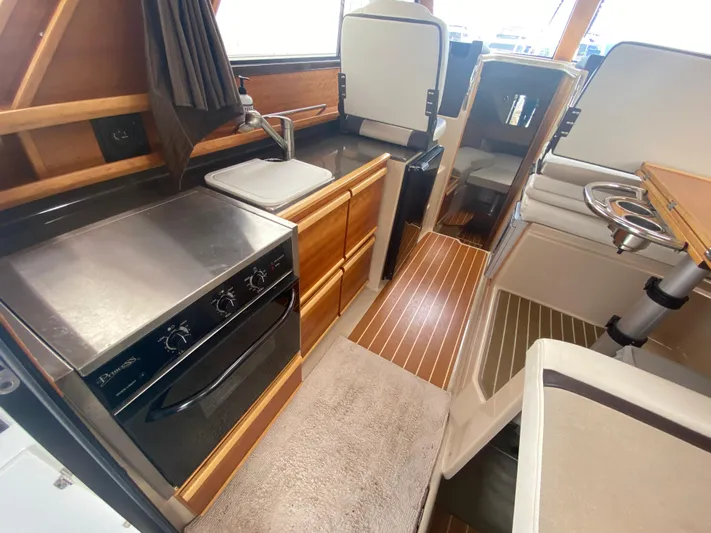  Yacht Photos Pics Interior of 2015 Cutwater C-28 boat featuring kitchen and seating area.