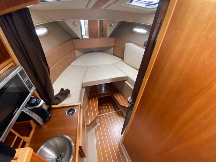  Yacht Photos Pics 2015 Cutwater C-28 cabin interior with kitchenette and seating area.