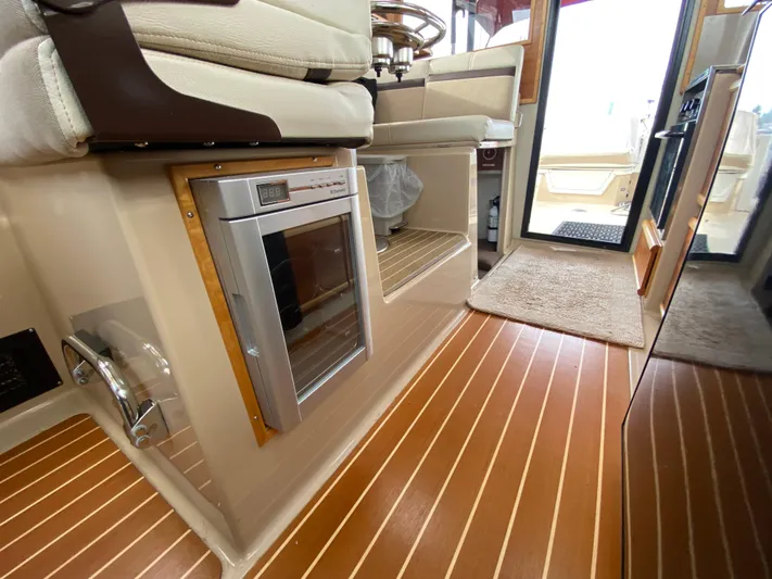 Yacht Photos Pics Interior of 2015 Cutwater C-28 boat with wood flooring and built-in appliances.
