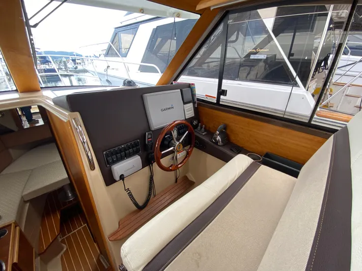  Yacht Photos Pics Interior of a 2015 Cutwater C-28 boat, featuring a steering wheel and navigation system.