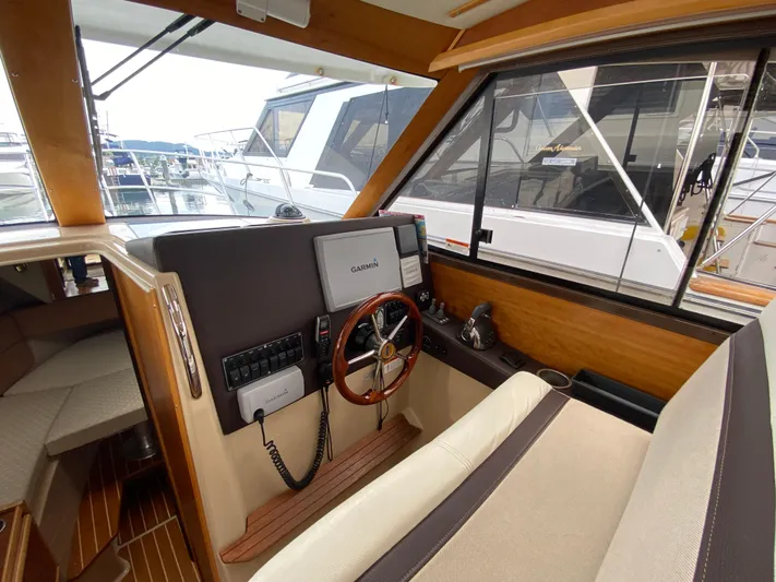  Yacht Photos Pics Interior of 2015 Cutwater C-28 boat with steering wheel and navigation equipment.