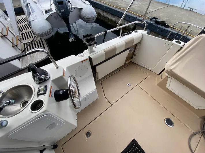  Yacht Photos Pics 2015 Cutwater C-28 boat cockpit with steering wheel, sink, and seating area.