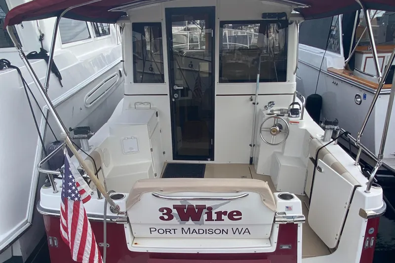  Yacht Photos Pics 2015 Cutwater C-28 boat docked, rear view with "3Wire" and American flag.
