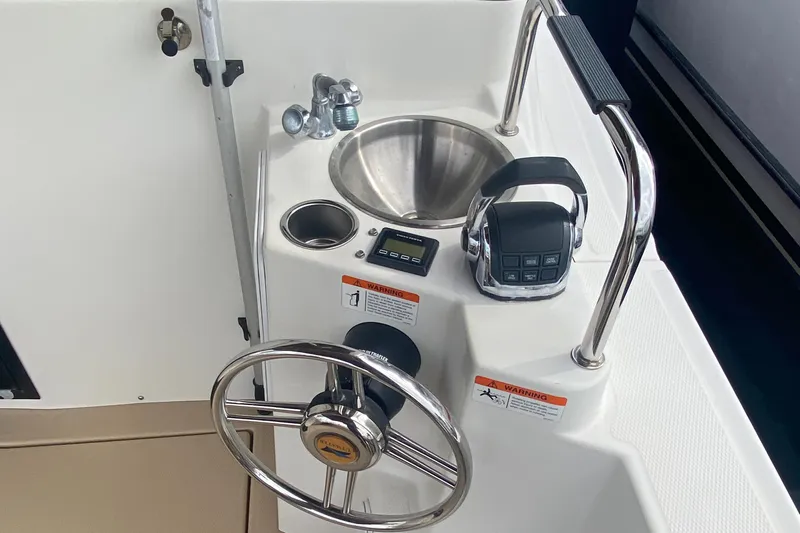  Yacht Photos Pics 2015 Cutwater C-28 helm with steering wheel, sink, and controls.