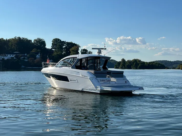 Southern Comfort Yacht Photos Pics 2022 Cruisers Yachts 390 Express Coupe on serene lake with scenic backdrop.