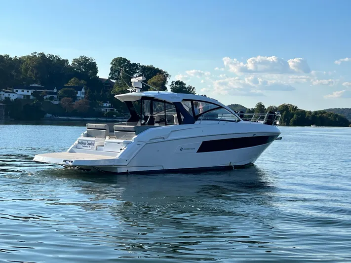 Southern Comfort Yacht Photos Pics 2022 Cruisers Yachts 390 Express Coupe on serene lake with scenic backdrop.