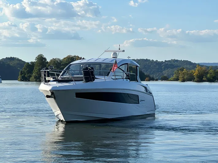 Southern Comfort Yacht Photos Pics 2022 Cruisers Yachts 390 Express Coupe on a serene lake with scenic background.