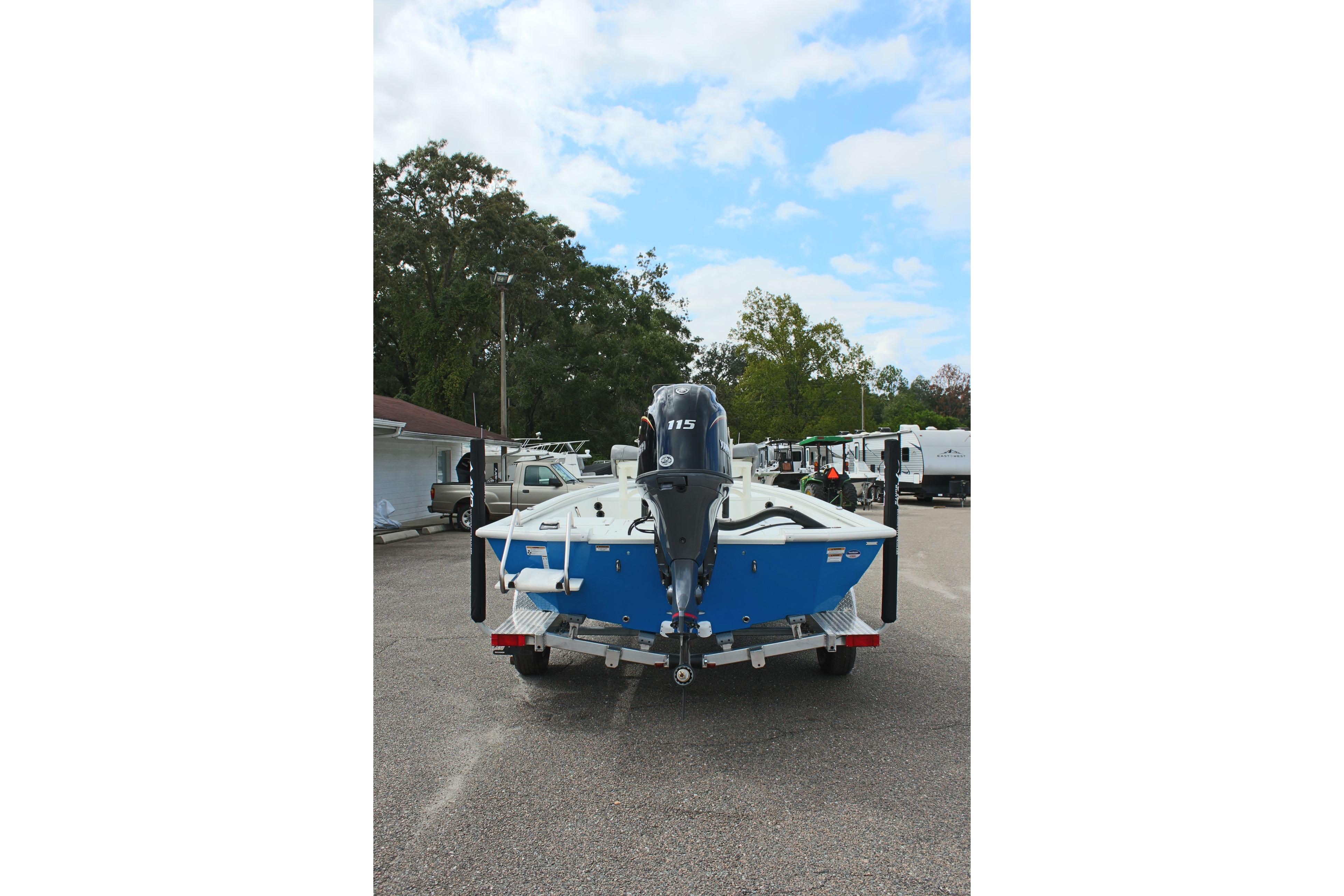 2026 Avid 19 FSX boat on trailer, parked outdoors, rear view.