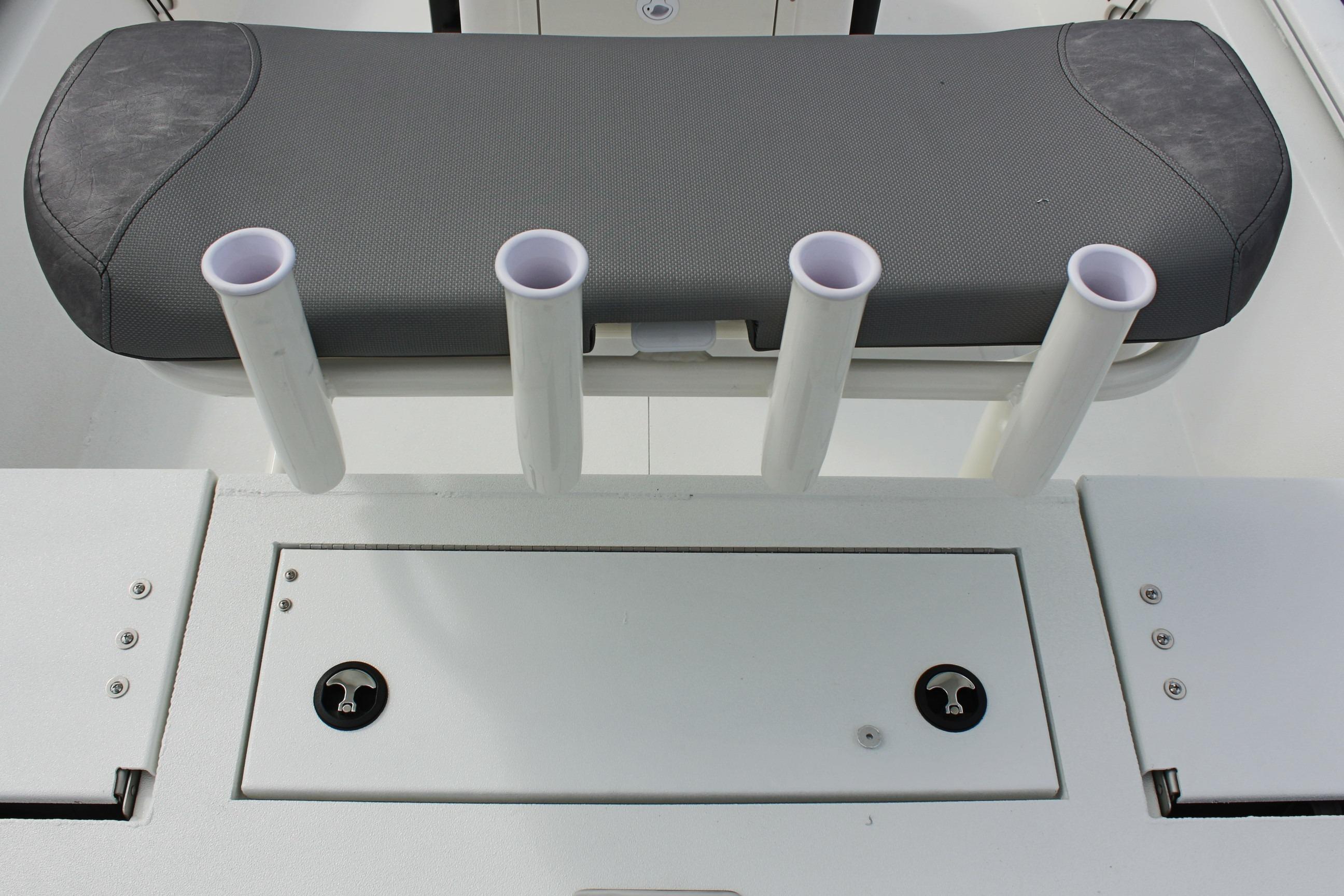 2026 Avid 19 FSX boat seat with rod holders and storage compartment.