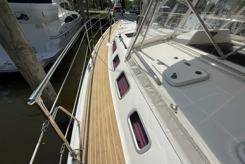  Yacht Photos Pics 2005 Hunter 46LE sailboat deck with wooden finish and stainless steel railings.