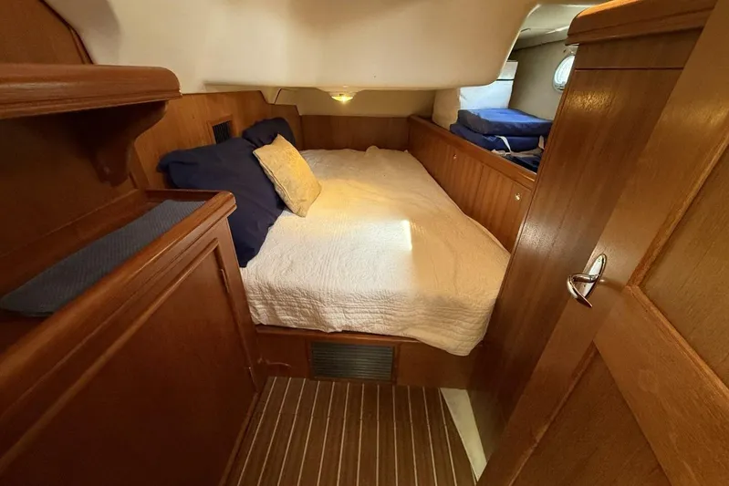  Yacht Photos Pics Cozy cabin interior of 2005 Hunter 46LE yacht with wooden finish and comfortable bedding.