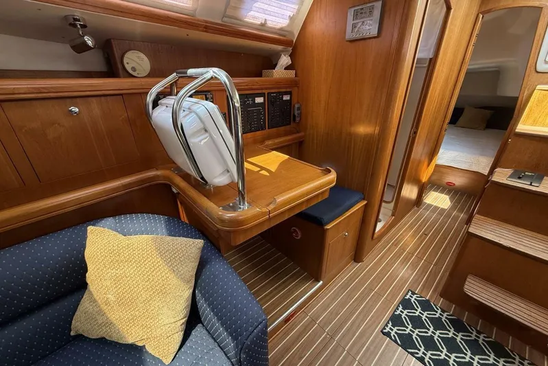  Yacht Photos Pics Interior of 2005 Hunter 46LE yacht with wooden finish and cozy seating area.