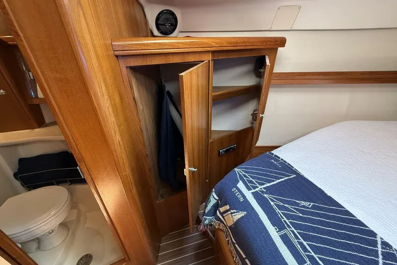  Yacht Photos Pics 2005 Hunter 46LE yacht interior with wooden closet, bed, and bathroom.