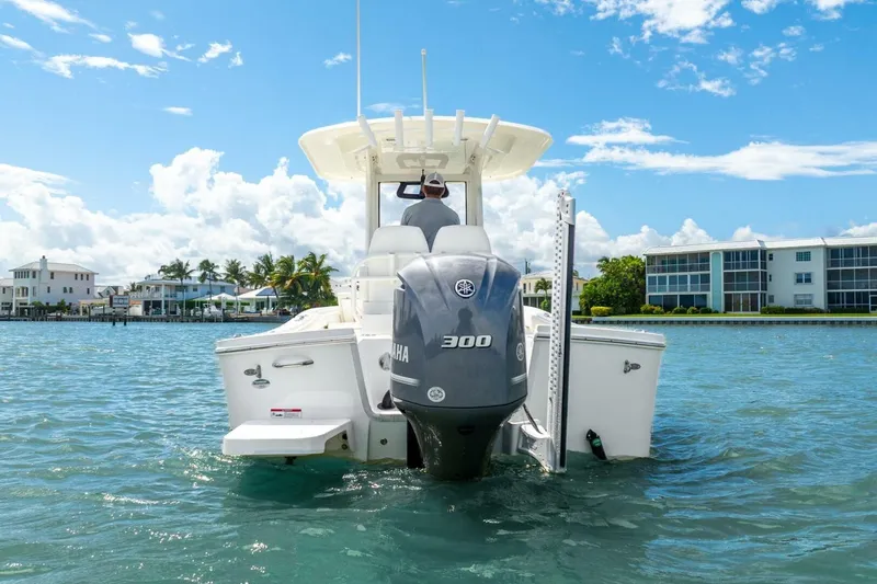  Yacht Photos Pics 2021 Regulator 26XO boat with Yamaha 300 engine on clear water, sunny day.