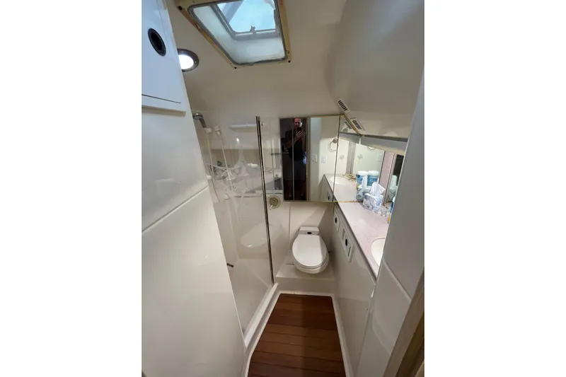 Possibilities Yacht Photos Pics Bathroom interior of 1992 Tiara Yachts 4300 Open, featuring shower, toilet, and sink.