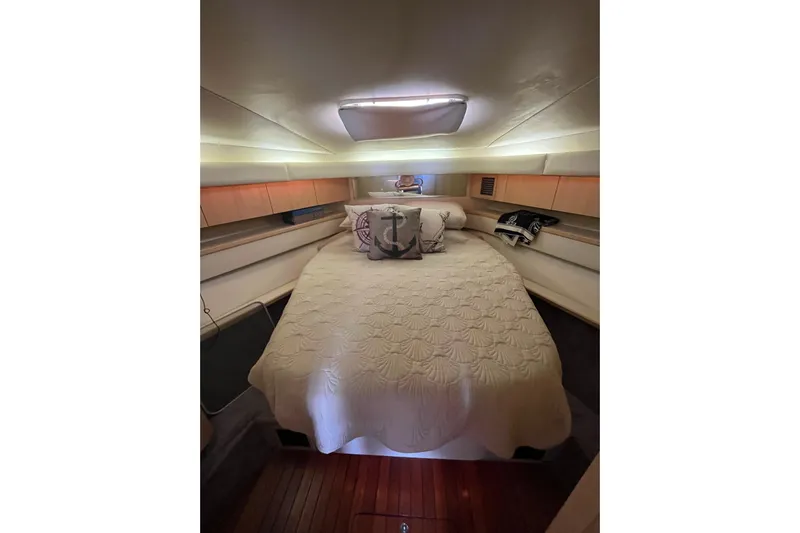 Possibilities Yacht Photos Pics Cozy cabin interior of 1992 Tiara Yachts 4300 Open with elegant bedding and soft lighting.