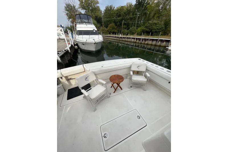 Possibilities Yacht Photos Pics 1992 Tiara Yachts 4300 Open deck with chairs and table, docked near another boat.