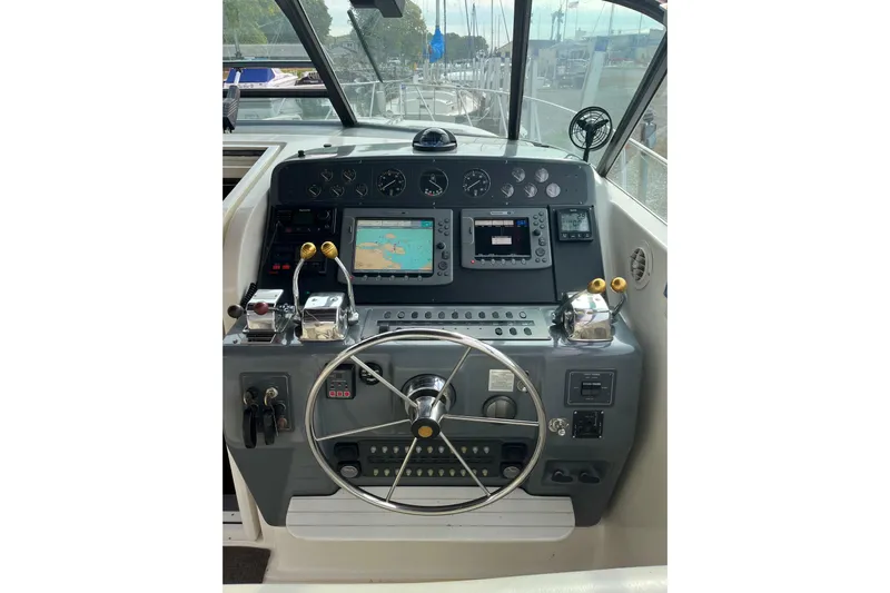 Possibilities Yacht Photos Pics Helm of 1992 Tiara Yachts 4300 Open with navigation equipment and steering wheel.