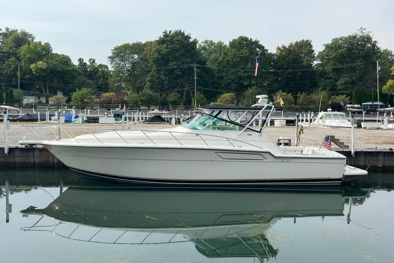 Possibilities Yacht Photos Pics 1992 Tiara Yachts 4300 Open docked in a serene marina setting.