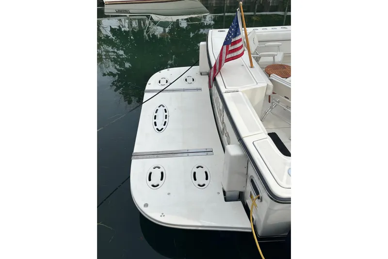 Possibilities Yacht Photos Pics 1992 Tiara Yachts 4300 Open with American flag, docked, showcasing swim platform.