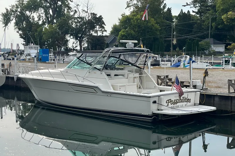 Possibilities Yacht Photos Pics 1992 Tiara Yachts 4300 Open docked, featuring sleek design and American flag.