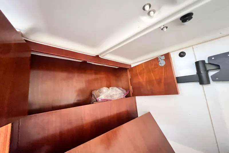 Windnsea Yacht Photos Pics Interior storage compartment of a 2001 Beneteau 473 sailboat with wooden finish.