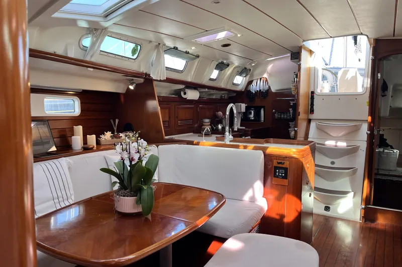 Windnsea Yacht Photos Pics Luxurious interior of a 2001 Beneteau 473 yacht with elegant wood finishes and modern amenities.