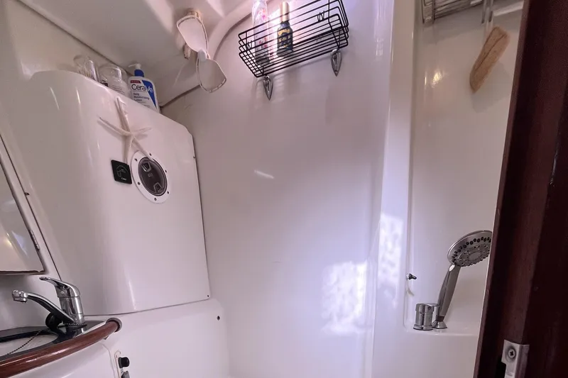 Windnsea Yacht Photos Pics Beneteau 473 2001 yacht bathroom with shower, sink, and toiletries.