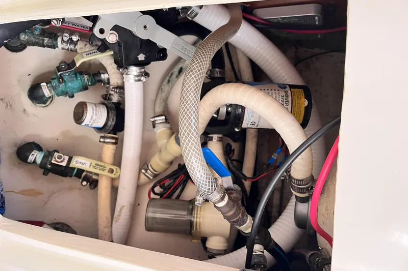Windnsea Yacht Photos Pics Plumbing system inside a 2001 Beneteau 473 yacht, featuring hoses and valves.