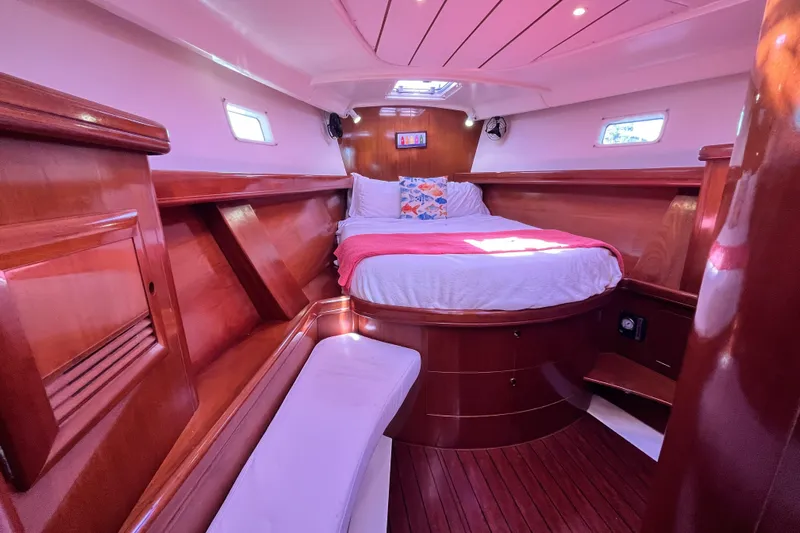 Windnsea Yacht Photos Pics Luxurious cabin interior of 2001 Beneteau 473 yacht with polished wood finish.