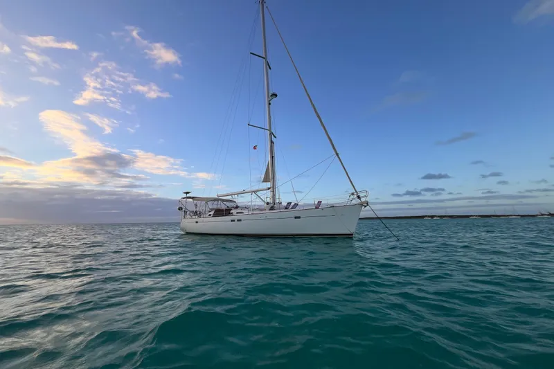 Windnsea Yacht Photos Pics Sailing yacht Beneteau 473, 2001 model, anchored on calm ocean at sunset.