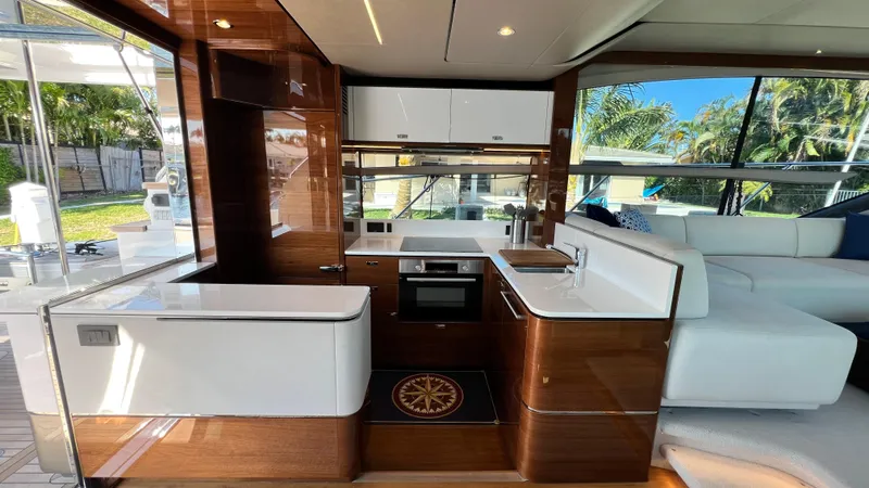 Sea Sea Elle Yacht Photos Pics Luxurious interior of 2019 Princess F62 yacht with modern kitchen and seating area.