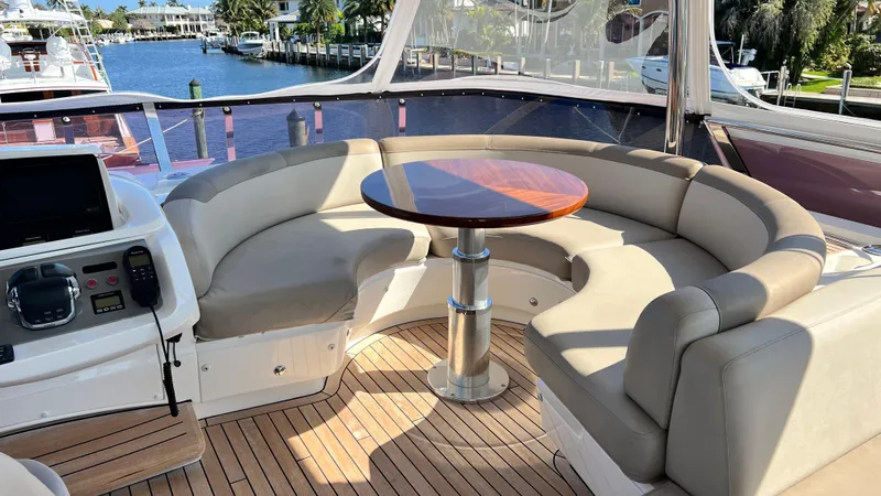 Sea Sea Elle Yacht Photos Pics Luxurious seating area on 2019 Princess F62 yacht with wooden table and waterfront view.