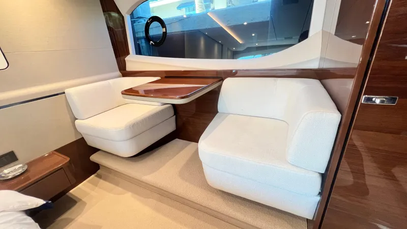 Sea Sea Elle Yacht Photos Pics Luxurious interior of 2019 Princess F62 yacht with elegant seating and wooden accents.