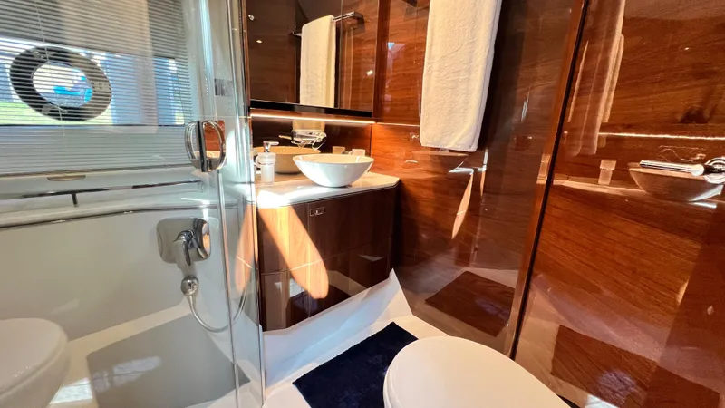 Sea Sea Elle Yacht Photos Pics Luxurious bathroom in 2019 Princess F62 yacht with modern fixtures and elegant wood paneling.